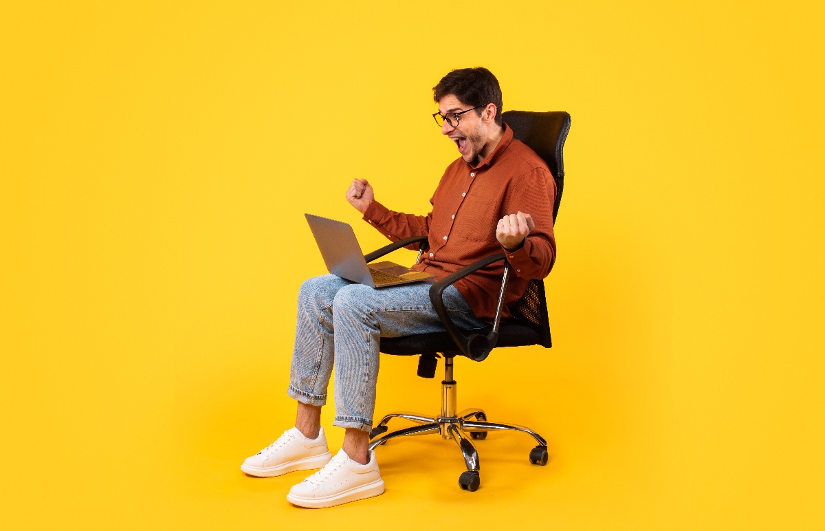 man sitting on office chair with laptop man sitting on office chair with laptop