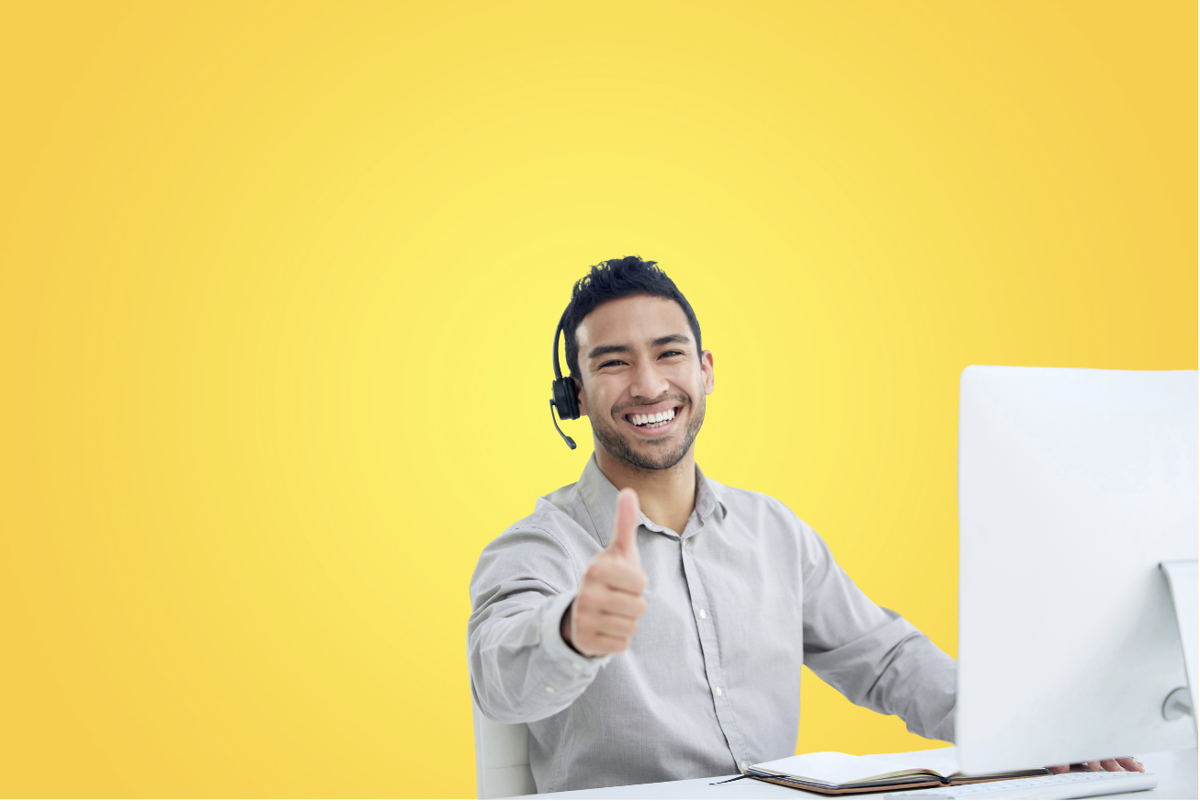 man showing thumps up next to his computer